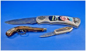 Two Commemorative/Display Pen Knives Together With A Lighter In The Form Of A Pistol.