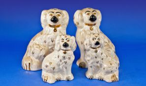 Two Pairs of Beswick Fire Side Spaniel Figures, in cream with black and gold highlights, one pair