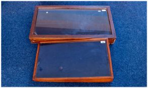 Two Glass Cased Table Top Vitrines, one sloping on the wide side, the cover opening from the base of
