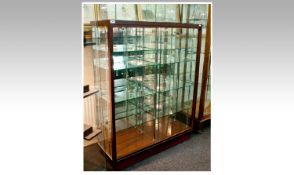 Modern Glass Display Cabinet, with a mahogany effect frame, with sliding glass doors to front,