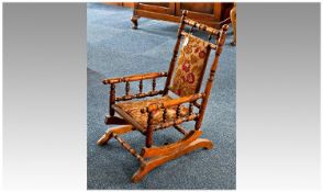 Beech Framed Child`s Rocking Chair, circa 1890, the back with padded cushion and turned uprights and
