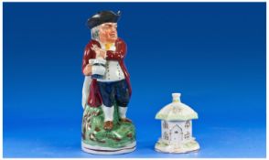 An Antique Staffordshire Toby Jug of ``Hearty Good Fellow`` Wearing a black hat and holding an ale