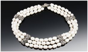 Triple Strand Fresh Water Pearl Necklace.