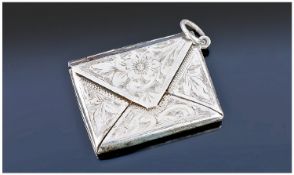 An Edwardian Novelty Silver Stamp Holder in the realistic form of an envelope. All over floral