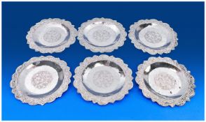 A Set of Six Persian Silver Plates. Each with floral tendril decoration to the wavy rim and