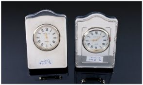 Two Silver Bedside Clocks with blue plush backings and supports. Both by G and C Kitney London