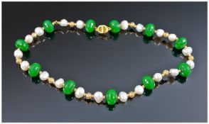 An Attractive Necklace consisting of eleven dark green jade spheres, interspersed between twenty