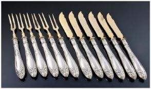 A Set Of Six German Silver Handled Hors D`oeuvre Knives and Forks. The gilded metal blades and tines