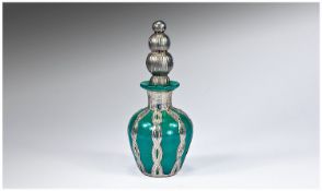 A Silver and Opaque Green Glass Scent Bottle. The neck and body overlaid in sterling silver and