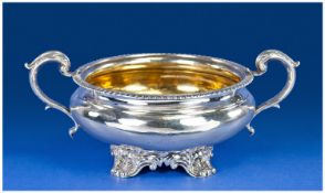 William IV Silver Two Handle Sugar Bowl With Reeded Border, raised on 4 shell feet. Gilt interior.