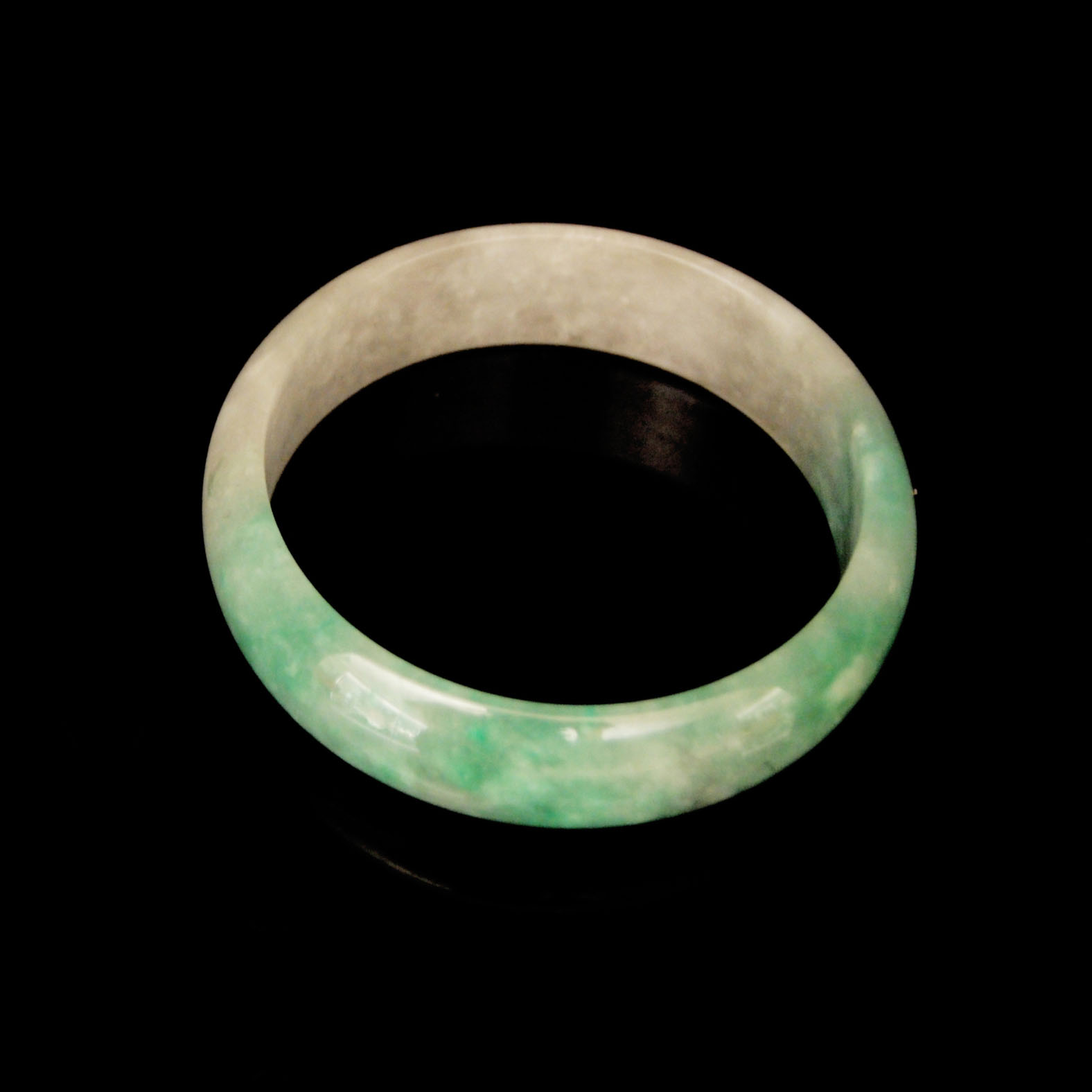??????????  Glass Jadeite Bracelet with Lustrous Green Mottling Diameter: 2¾ in. (7.1 cm.)