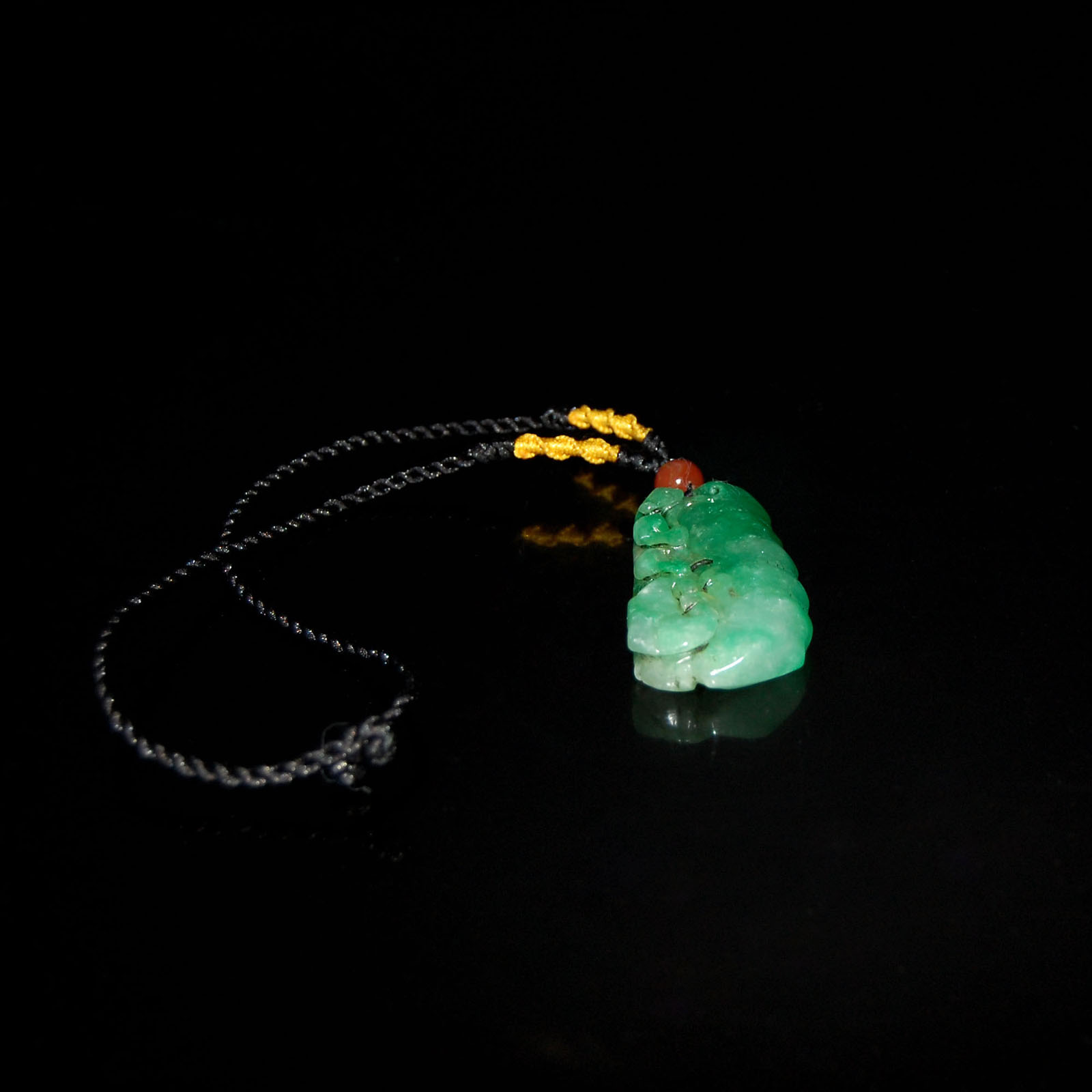 ???????????  A Jadeite Pendant Carved on Both Sides with Ruyi and Bamboo Sections Height: 2? in. (