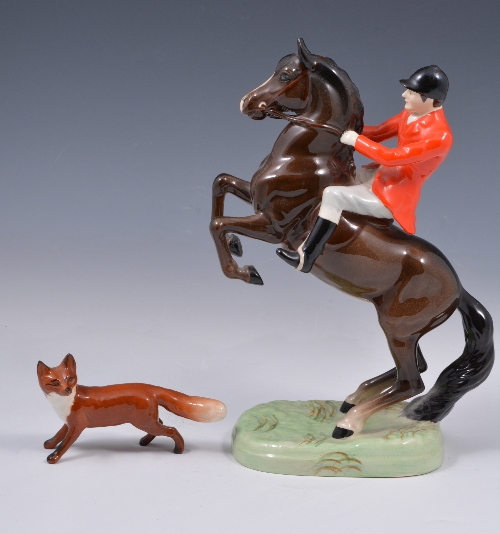 A Beswick equestrian model of a Huntsman on a rearing horse, number 868, 24cm.