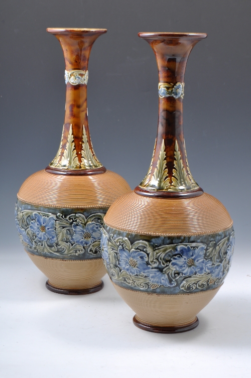 A pair Doulton Lambeth stoneware bottle vases, floral decoration on a broad band and a near