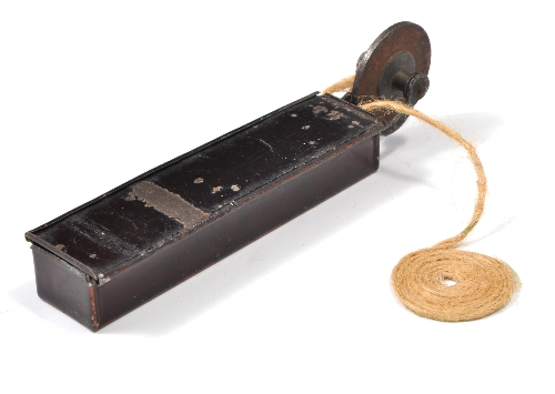 Antique wheel tinder-box, in a display case.