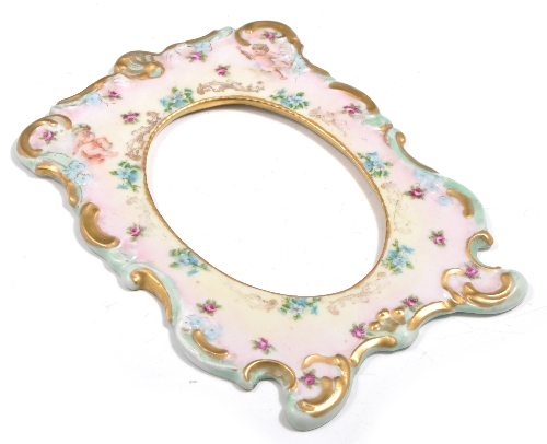 An Austrian Porcelain picture frame facia, decorated with cherubs and flowers, 23cm