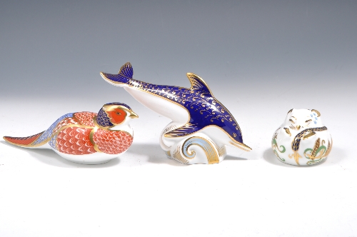 A Royal Crown Derby paperweight, model as a Dolphin, 10cm and two others, a Pheasant and a Field