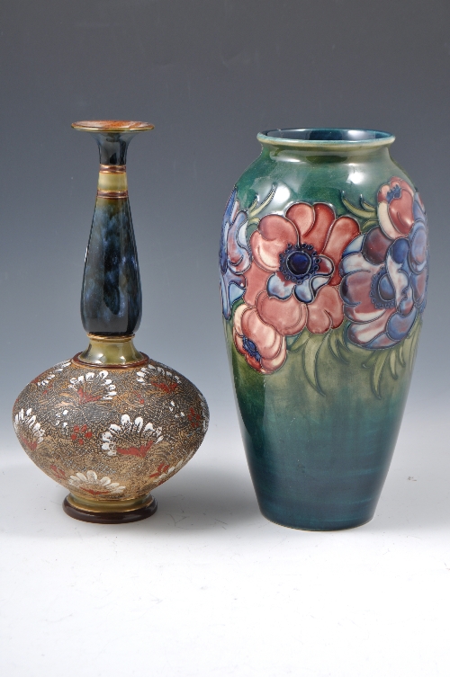 A Moorcroft pottery ovoid vase, Magnolia design on a blue-green ground, repair, 27cm and a Doulton