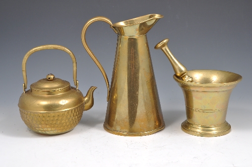 Brass mortar and pestle, a brass conical jug and a small brass teapot, (4).