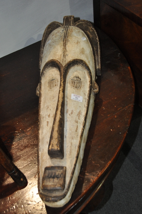 Tribal art: carved wood ceremonial mask, probably Gabon, modelled as an elongated face, with sharp
