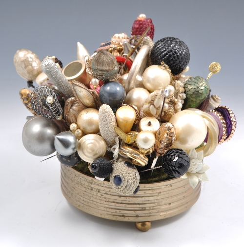 Metal framed pin cushion, with a collection of hat pins.