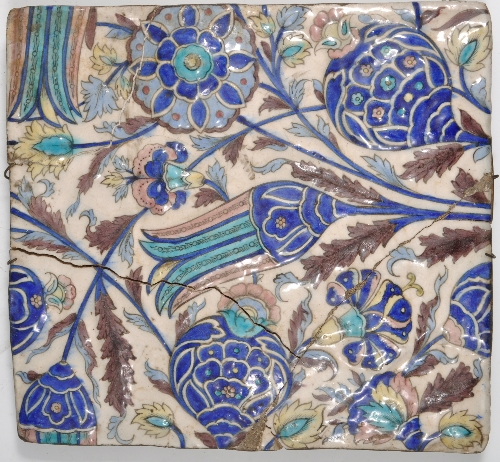 Large Isnik style tile, possible 18th Century, moulded and painted with flowers, 35 x 32cms.