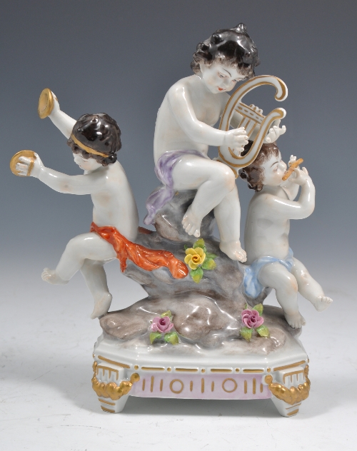 German porcelain group, modelled with three musical cherubs, encrusted and painted decoration,