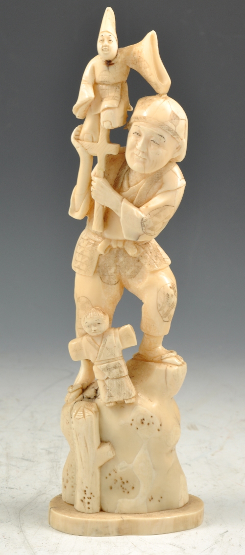 Japanese carved ivory Okimono of a Puppeteer, three character mark, 24cms.