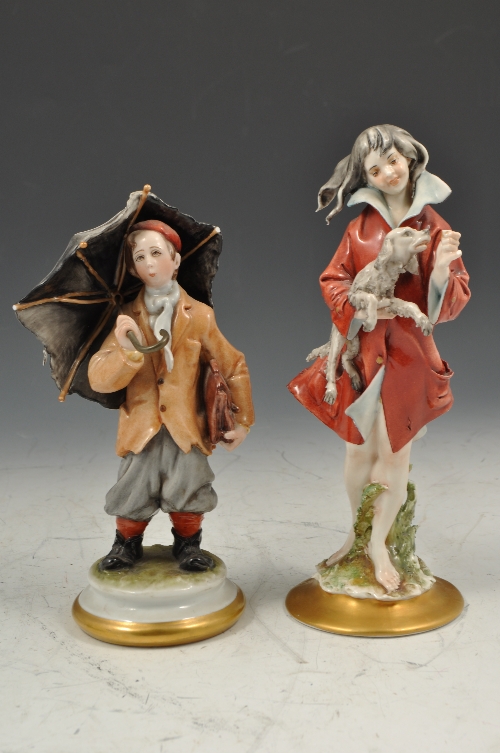 Capodimonte painted Parian figure, of a boy with an umbrella, 24cms and three other Capodimonte