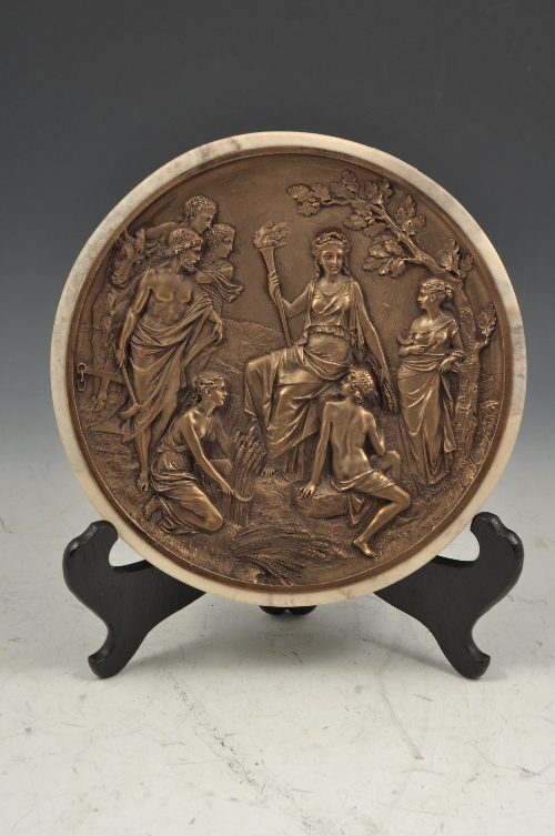 Reproduction bronzed plaque, classical scene, in a marble effect surround, diameter 22cms.