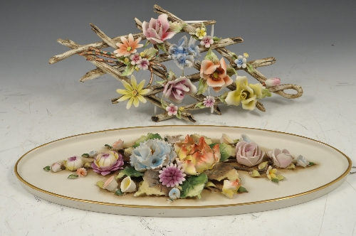 Capodimonte oval plaque, encrusted with flowers, 39cms and a floral trellis plaque, (2).