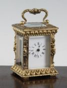A French gilt brass miniature carriage timepiece, with caryatid corners and enamelled Roman dial,