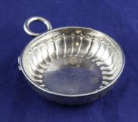 A French Louis XV silver taste vin, of circular form, with fluted decoration and serpent ring