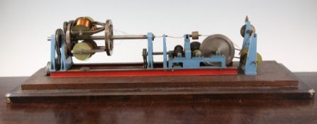 A mechanical scale model of a winding machine, upon mahogany base, 26in.
