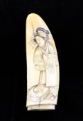 An unusual Japanese scrimshaw sperm whale tooth, Meiji period, carved in low relief with the