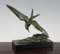 Irenee Rochard. An Art Deco bronze model of a tern flying above waves, signed, with black marble