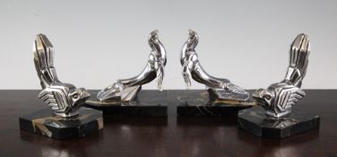 H. Moreau. Two pairs of Art Deco chromed metal bookends, modelled as seated birds and sea lions,