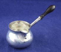 An early George II silver brandy saucepan, of plain bulbous form, with turned wooden handle, John