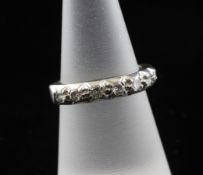 An 18ct white gold and diamond set half eternity ring, set with seven stones, size L.