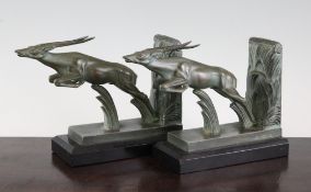 M. Le Verrier. A pair of bronzed metal bookends modelled as leaping gazelles, signed, 5in.