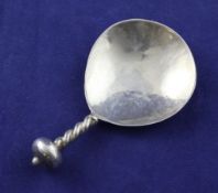 A George V Art & Crafts silver caddy spoon by Albert Edward Jones, with spiral stem and bun
