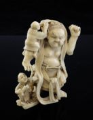 A Japanese ivory group, early 20th century, carved as a giant statue with four sculptors working