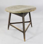 An early 19th century pine cricket table, formerly painted, remnants remaining, 2ft 8in.