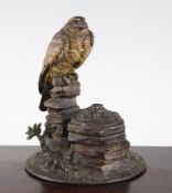 A 19th century Austrian cold painted bronze inkwell, modelled as a bird perched on a naturalistic