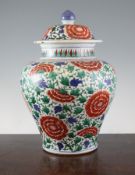 A large Chinese Wucai baluster jar and cover, Shunzhi period, painted with iron red flowers,