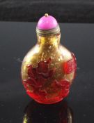 A Chinese ruby and amber glass overlaid snuff bottle, Qianlong seal mark but later, decorated with