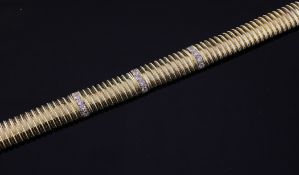 An 18ct gold and diamond articulated bracelet, set with three rows of five diamonds, gross 23 grams,