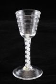 A Lynn opaque twist stem wine glass, c.1760-70, with horizontal moulded round funnel bowl, on an