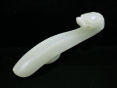 A Chinese pale celadon jade belt hook, 18th century, with dragon head terminal and plain curved