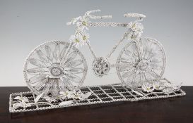 A 20th century French beadwork funeral stand, modelled as a bicycle with flowers, 19in.